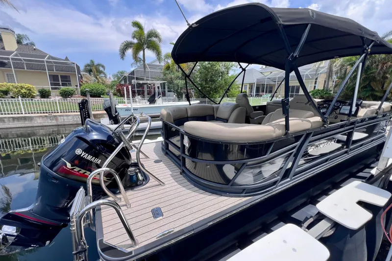 Slide: The Image of 2021 Starcraft SLS 3 pontoon boat with Yamaha engine, docked by waterfront homes. - 9
