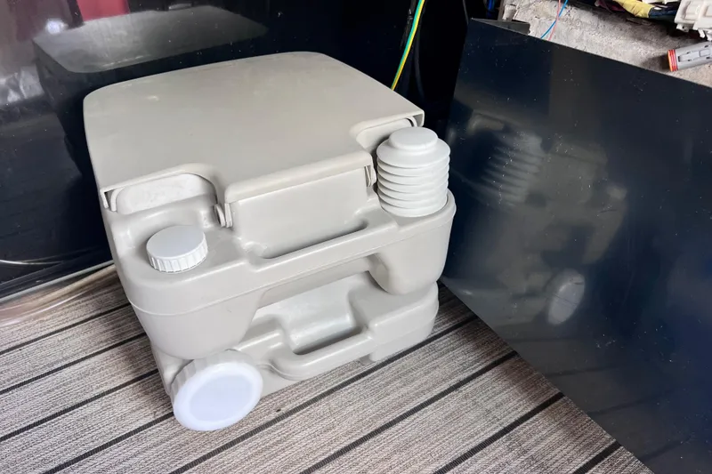 Slide: The Image of Portable camping toilet, Starcraft SLS 3 model, 2021, on striped floor. - 44