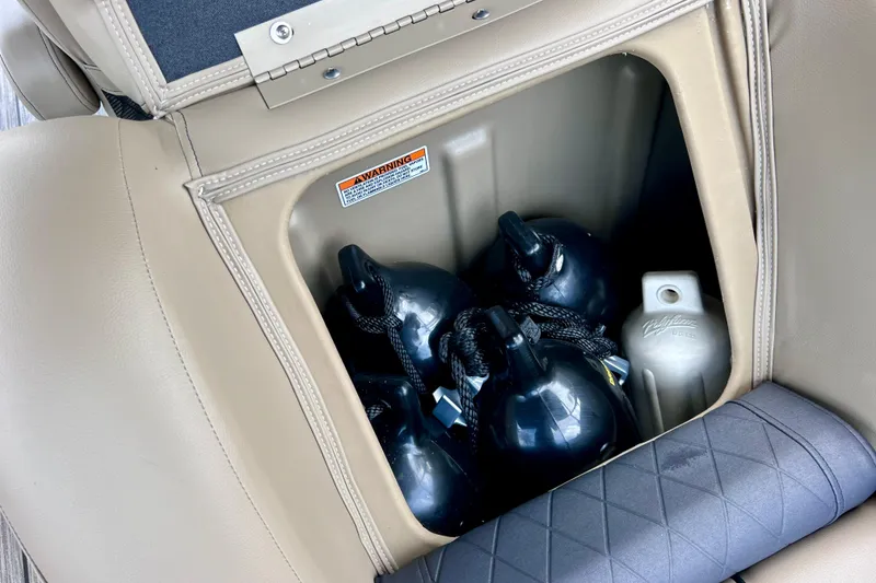Slide: The Image of Storage compartment in a 2021 Starcraft SLS 3 boat with fenders and a bottle. - 26