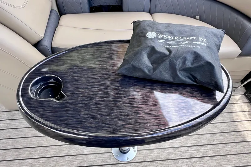 Slide: The Image of Oval table with cup holder on 2021 Starcraft SLS 3 boat, featuring Smoker Craft bag. - 43