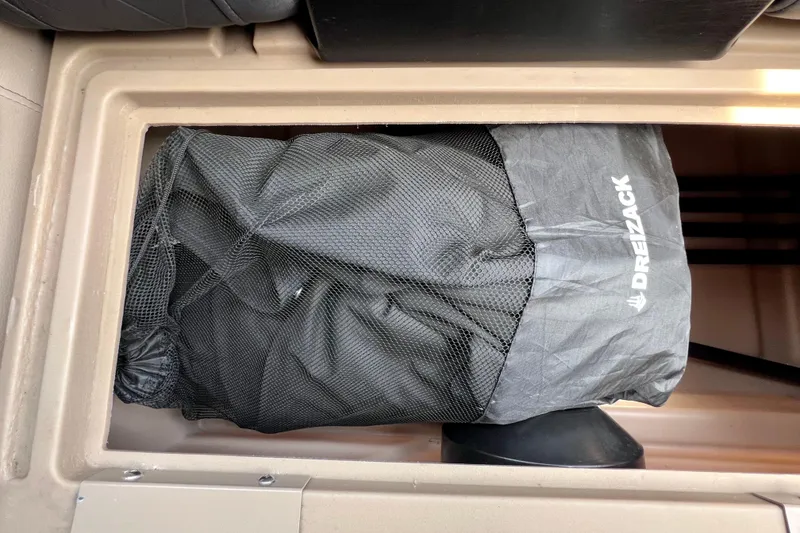 Slide: The Image of Storage compartment in a 2021 Starcraft SLS 3 boat with Dreizack bag inside. - 29