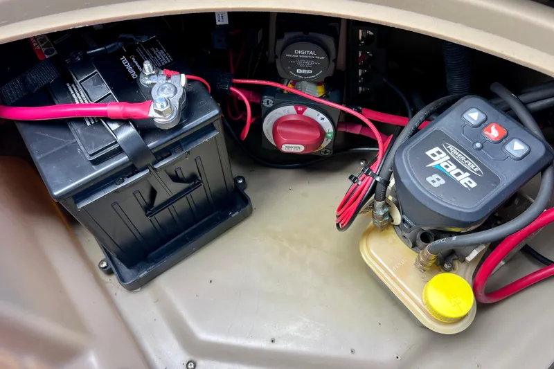 Slide: The Image of 2021 Starcraft SLS 3 boat battery compartment with wiring and power components. - 24
