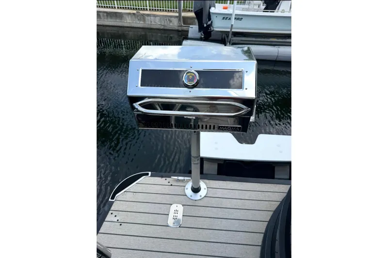 Slide: The Image of Stainless steel grill mounted on a 2021 Starcraft SLS 3 boat deck by the water. - 50