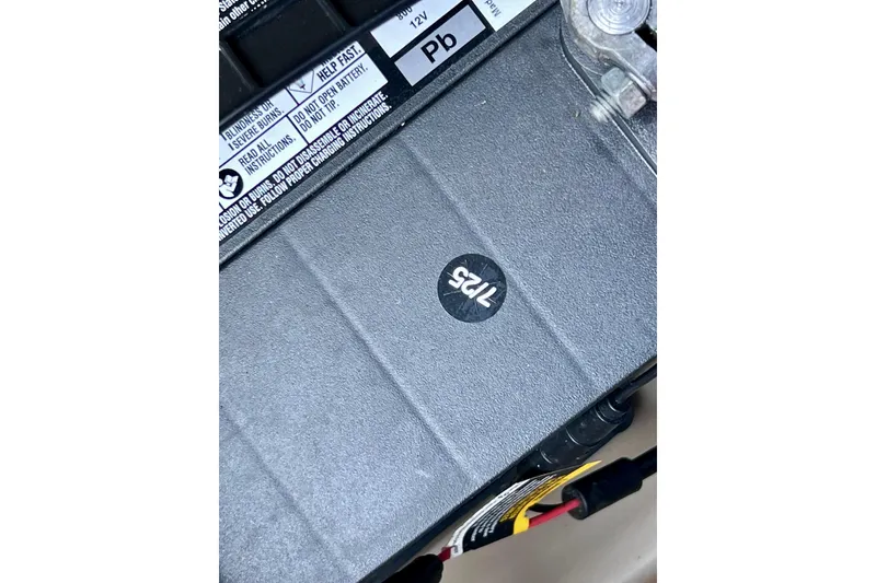 Slide: The Image of Battery of a 2021 Starcraft SLS 3, showing warning labels and connections. - 23
