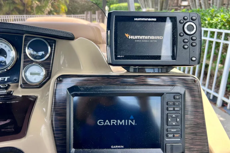Slide: The Image of Dashboard of a 2021 Starcraft SLS 3 boat featuring Humminbird and Garmin displays. - 34