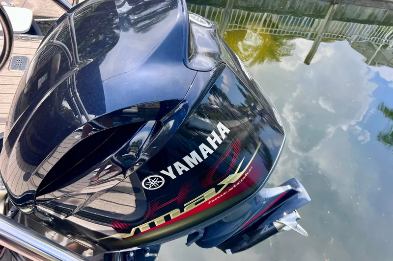 Slide: The Image of Yamaha outboard motor on a 2021 Starcraft SLS 3 boat, docked by water. - 14