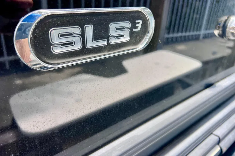 Slide: The Image of Close-up of 2021 Starcraft SLS 3 emblem on a sleek black surface. - 5