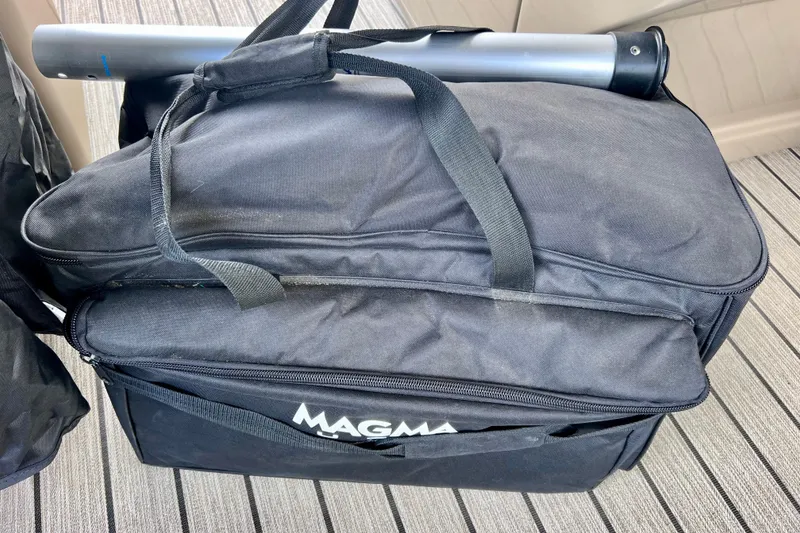 Slide: The Image of Black Magma bag on striped surface, containing a cylindrical object. Starcraft SLS 3, 2021. - 32