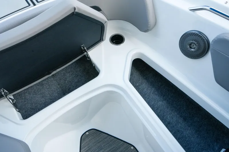 Slide: The Image of 2027 Four Winns HD2 OB boat interior with open storage compartment and speaker. - 25