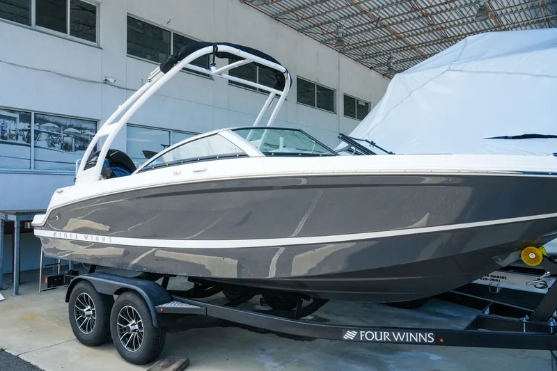 Slide: The Image of 2027 Four Winns HD2 OB boat on trailer, sleek design, parked indoors. - 2