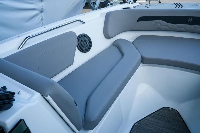 Slide: The Image of 2027 Four Winns HD2 OB boat interior with gray seating and speaker. - 20