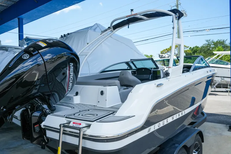 Slide: The Image of 2027 Four Winns HD2 OB boat with Mercury outboard engine, displayed outdoors. - 4