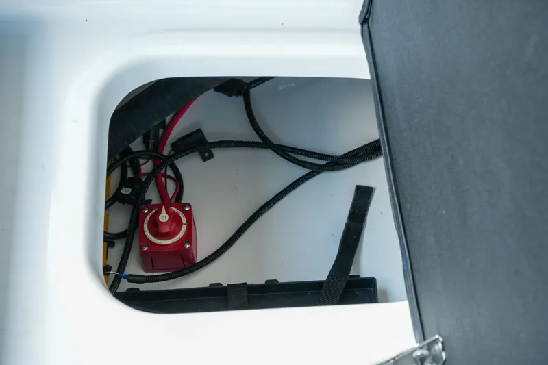 Slide: The Image of 2027 Four Winns HD2 OB boat compartment with wiring and red switch. - 32