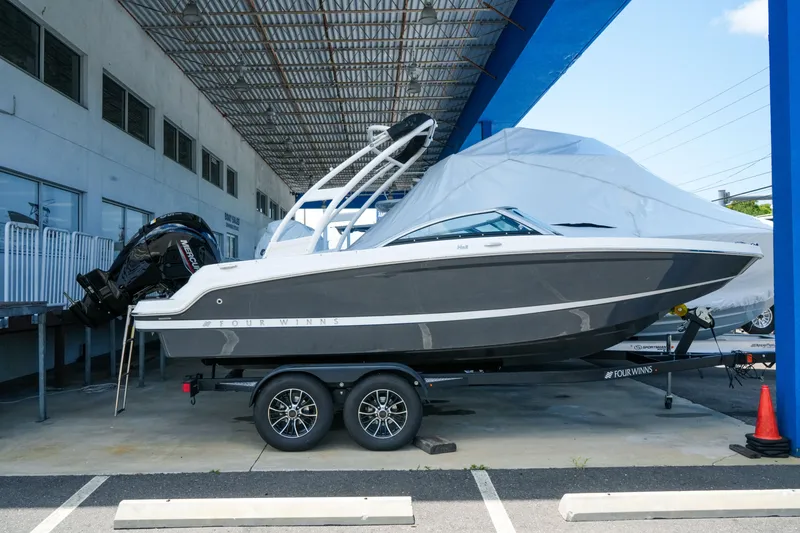 The Image of 2027 Four Winns HD2 OB boat on trailer under a canopy, side view. - 1