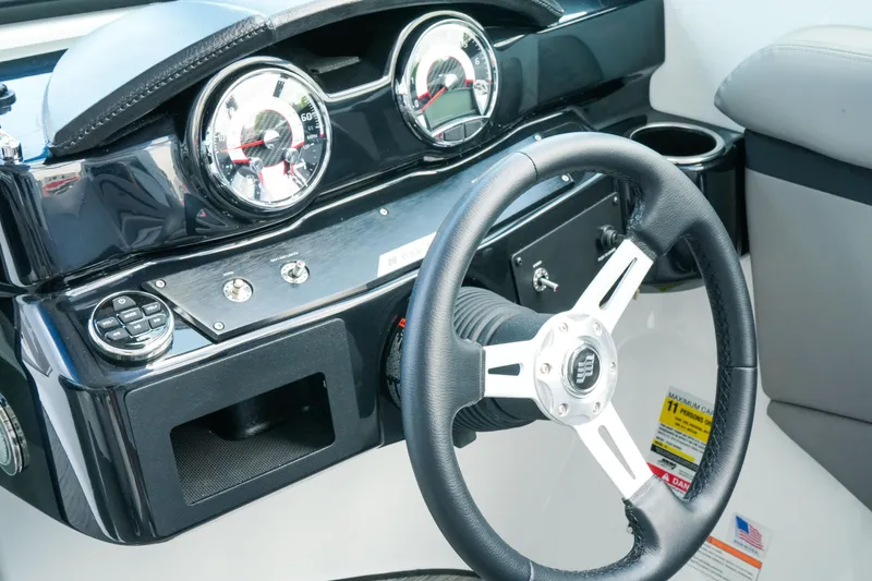 Slide: The Image of 2027 Four Winns HD2 OB boat dashboard with steering wheel and gauges. - 15