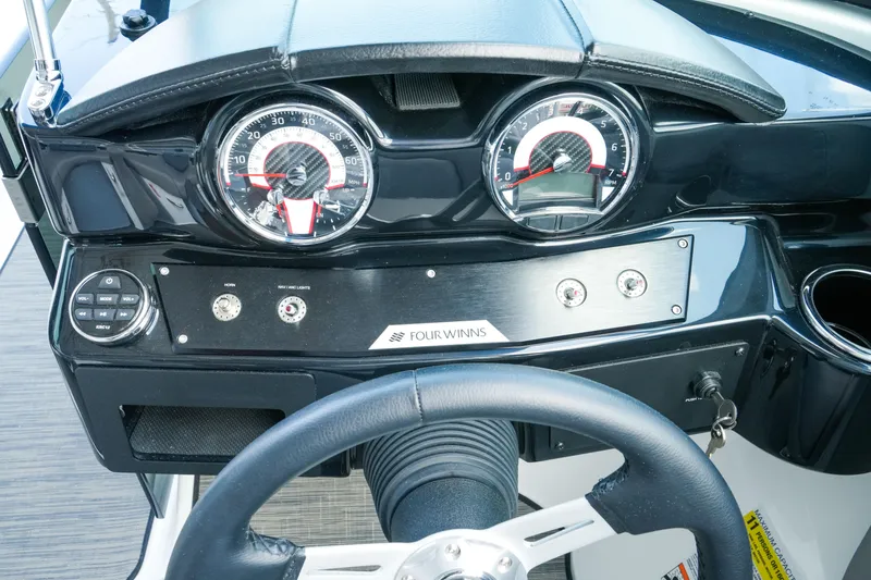 Slide: The Image of Dashboard of 2027 Four Winns HD2 OB boat with gauges and controls. - 16