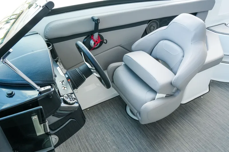 Slide: The Image of 2027 Four Winns HD2 OB boat cockpit with steering wheel and plush captain's chair. - 27