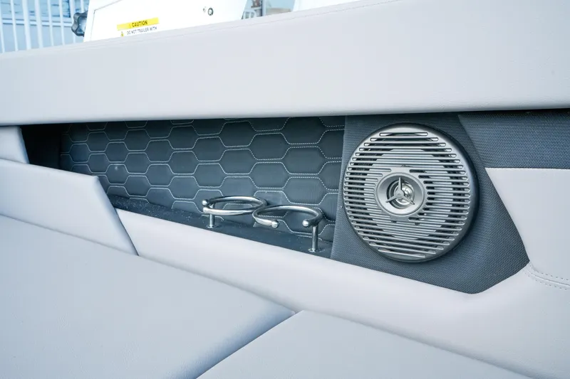 Slide: The Image of 2027 Four Winns HD2 OB boat interior with speaker and cup holders. - 11