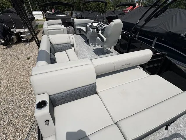 Slide: The Image of The image shows the spacious deck of a 2026 Harris Cruiser 230 with comfortable seating. - 9