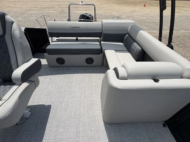 Slide: The Image of 2026 Harris Cruiser 230 with gray upholstered seating and carpeted floor, ideal for comfort on the water. - 7