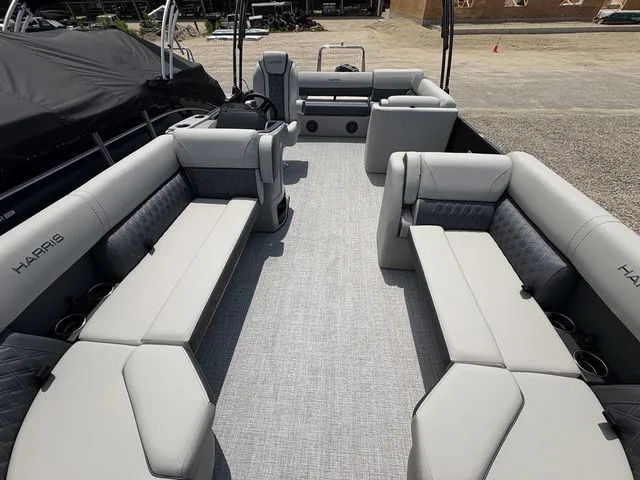 Slide: The Image of The image shows the interior of a Harris Cruiser 230 pontoon boat with gray upholstery and seating. - 4