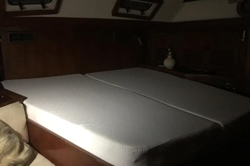 Slide: The Image of Cabin interior of 1987 Tayana 52 yacht with a neatly made bed. - 19