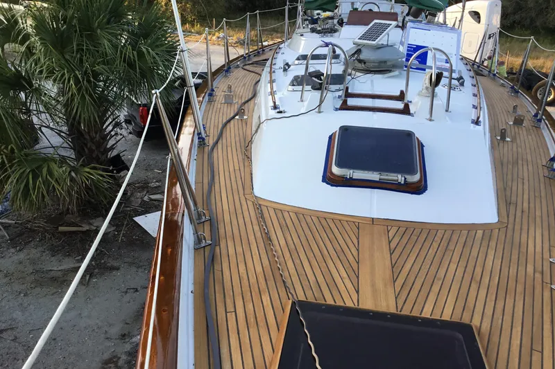 Slide: The Image of Deck view of 1987 Tayana 52 sailboat with teak finish and solar panel. - 22