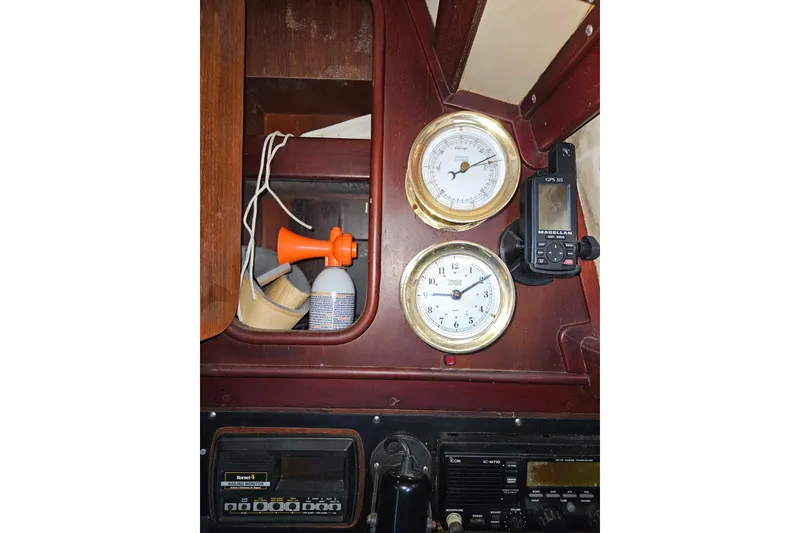 Slide: The Image of Interior of 1987 Tayana 52 yacht with barometer, clock, and GPS device. - 25