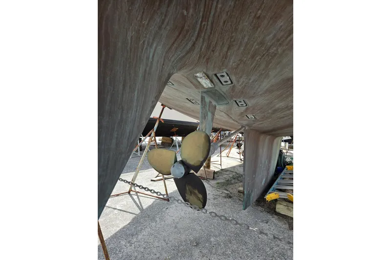 Slide: The Image of 1987 Tayana 52 sailboat underbody with propeller and rudder in dry dock. - 40