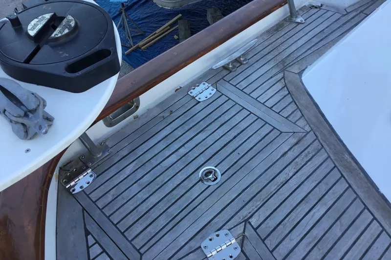 Slide: The Image of Teak deck of 1987 Tayana 52 sailboat with metal fittings and winch. - 10