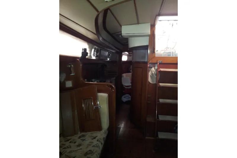 Slide: The Image of Interior of 1987 Tayana 52 sailboat with wooden furnishings and cozy cabin layout. - 16