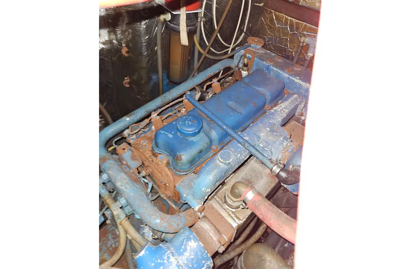 Slide: The Image of A blue engine with rust spots in an engine room. - 41