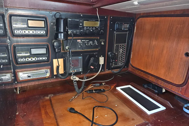 Slide: The Image of Navigation and communication equipment inside a 1987 Tayana 52 yacht cabin. - 21