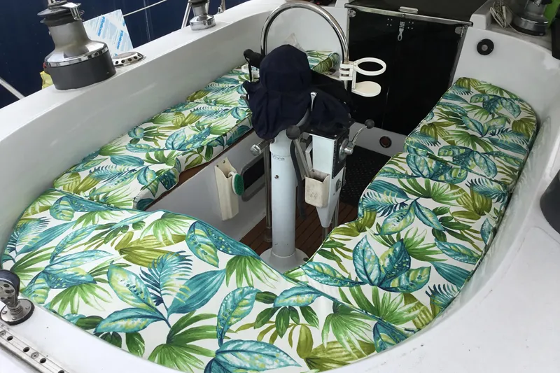 Slide: The Image of Cockpit of 1987 Tayana 52 sailboat with tropical leaf-patterned cushions. - 23