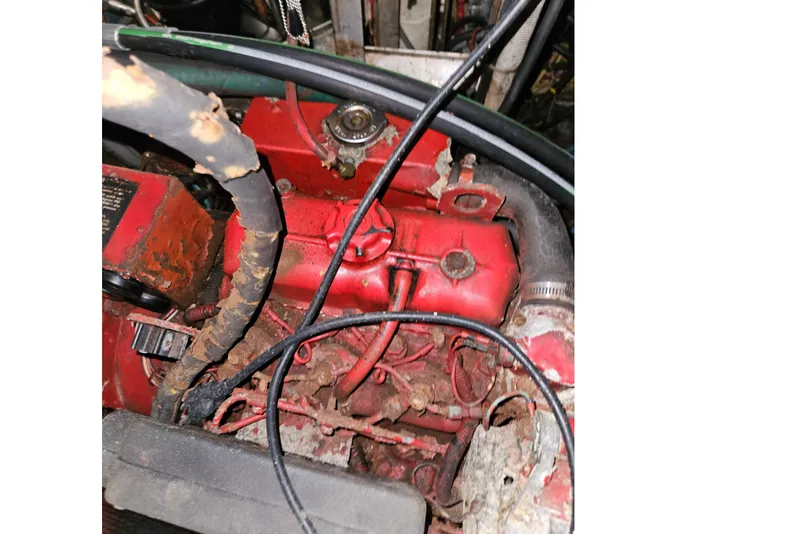 Slide: The Image of Close-up of a red engine with hoses and wires in a 1987 Tayana 52. - 42