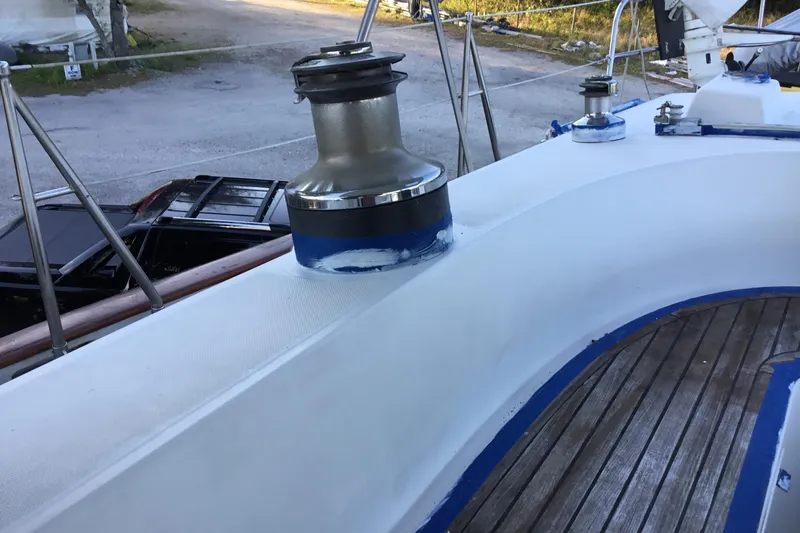Slide: The Image of Deck of 1987 Tayana 52 sailboat with winch and wooden flooring. - 11