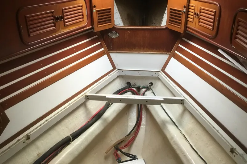Slide: The Image of Interior of 1987 Tayana 52 sailboat with wooden paneling and visible wiring. - 30