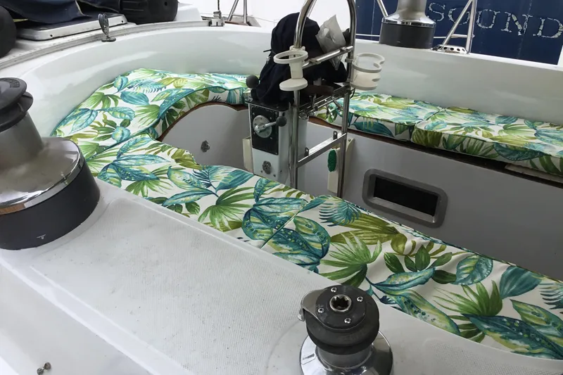 Slide: The Image of Cockpit of 1987 Tayana 52 sailboat with tropical-patterned cushions and winch. - 24