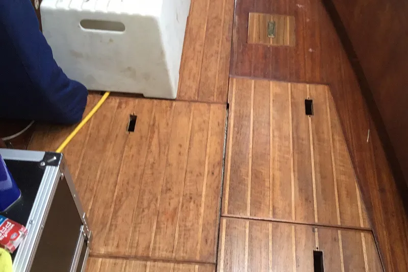 Slide: The Image of Wooden deck of a 1987 Tayana 52 sailboat with storage compartments. - 29
