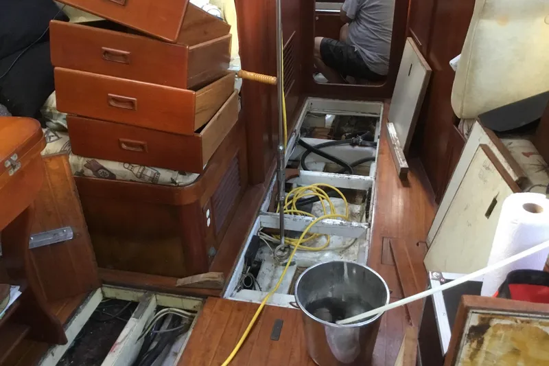Slide: The Image of Interior of a 1987 Tayana 52 sailboat under maintenance, with open floor panels. - 31