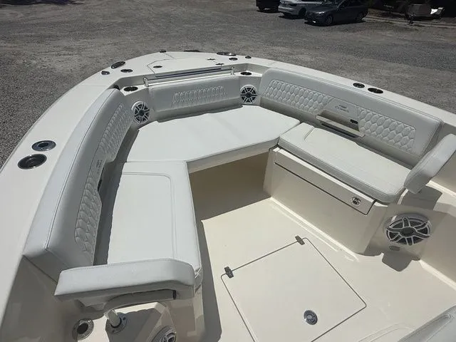 Slide: The Image of The 2025 Cobia 265 Open Center Console features a spacious, cushioned seating arrangement in the bow area. - 9