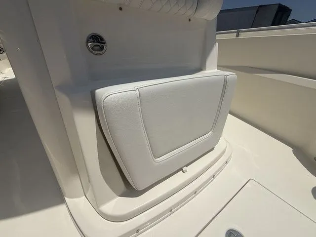 Slide: The Image of The 2025 Cobia 265 Open Center Console features a cushioned seat and a clean deck. - 13
