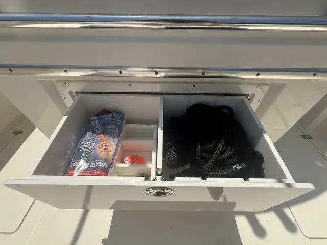 Slide: The Image of An open drawer on a boat reveals ropes and snacks. - 22