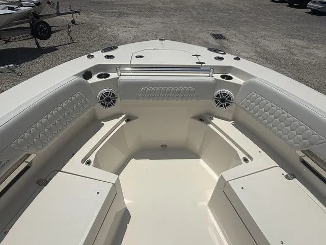 Slide: The Image of The image shows the bow of a 2025 Cobia 265 Open Center Console boat with cushioned seating. - 8