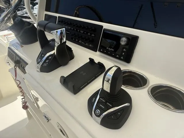 Slide: The Image of The image shows the helm of a Cobia 265 Open Center Console boat with modern controls. - 15