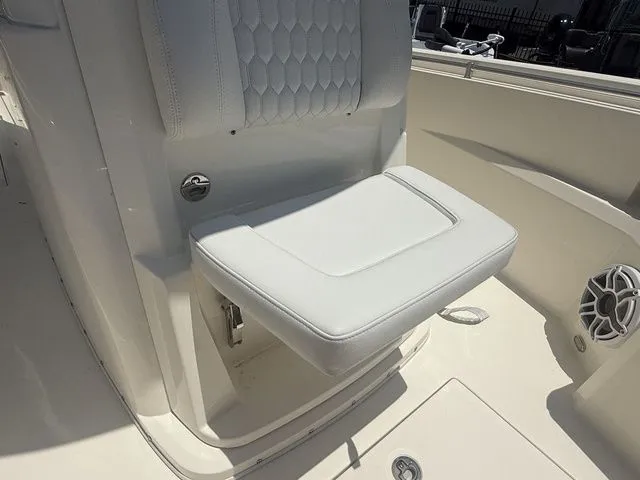 Slide: The Image of A white seat with padded backrest on a Cobia 265 Open Center Console boat. - 12