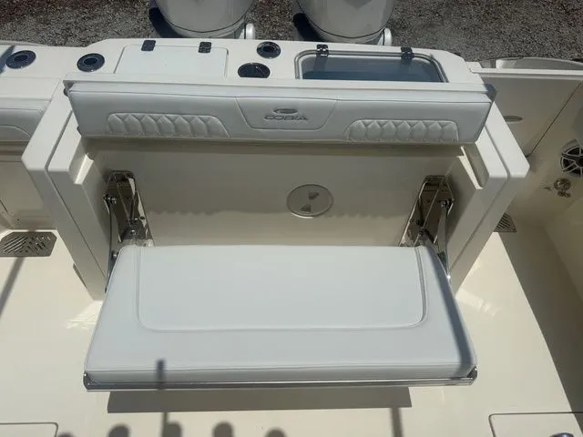 Slide: The Image of The 2025 Cobia 265 Open Center Console features a fold-down bench seat in the aft area. - 29
