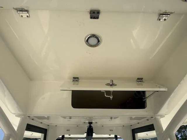 Slide: The Image of Interior view of a Cobia 265 Open Center Console with storage compartment and lighting. - 17