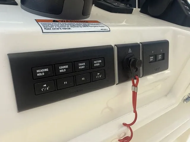 Slide: The Image of Close-up of the helm console featuring various controls and a safety lanyard. - 16