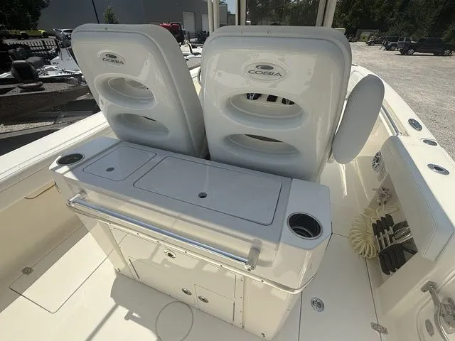 Slide: The Image of The image shows the cockpit of a 2025 Cobia 265 Open Center Console boat with two seats. - 23